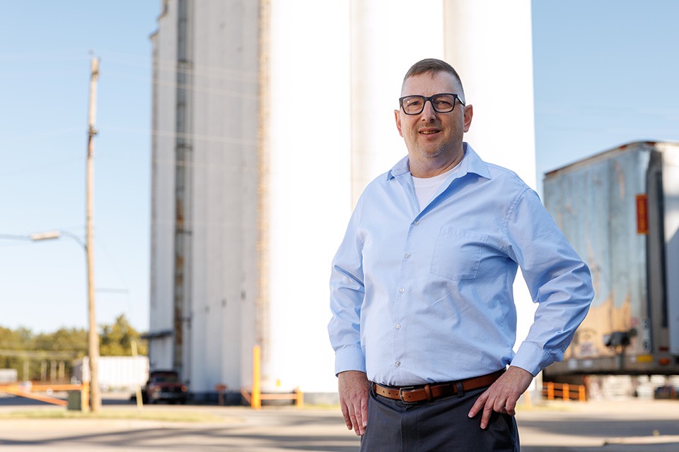 OSU grain marketing specialist Todd Hubbs stands in front of a grain silo in Stillwater.