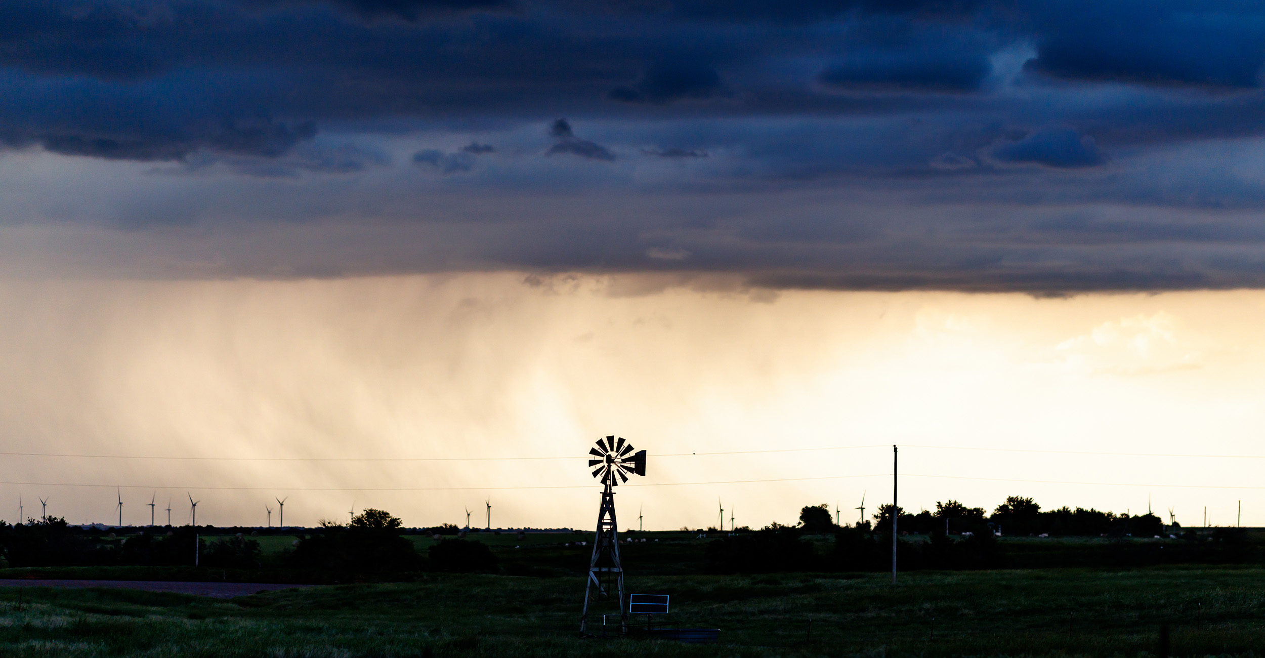 Windmill during a cloudy sunset.