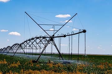 An irrigation system watering a crop field.