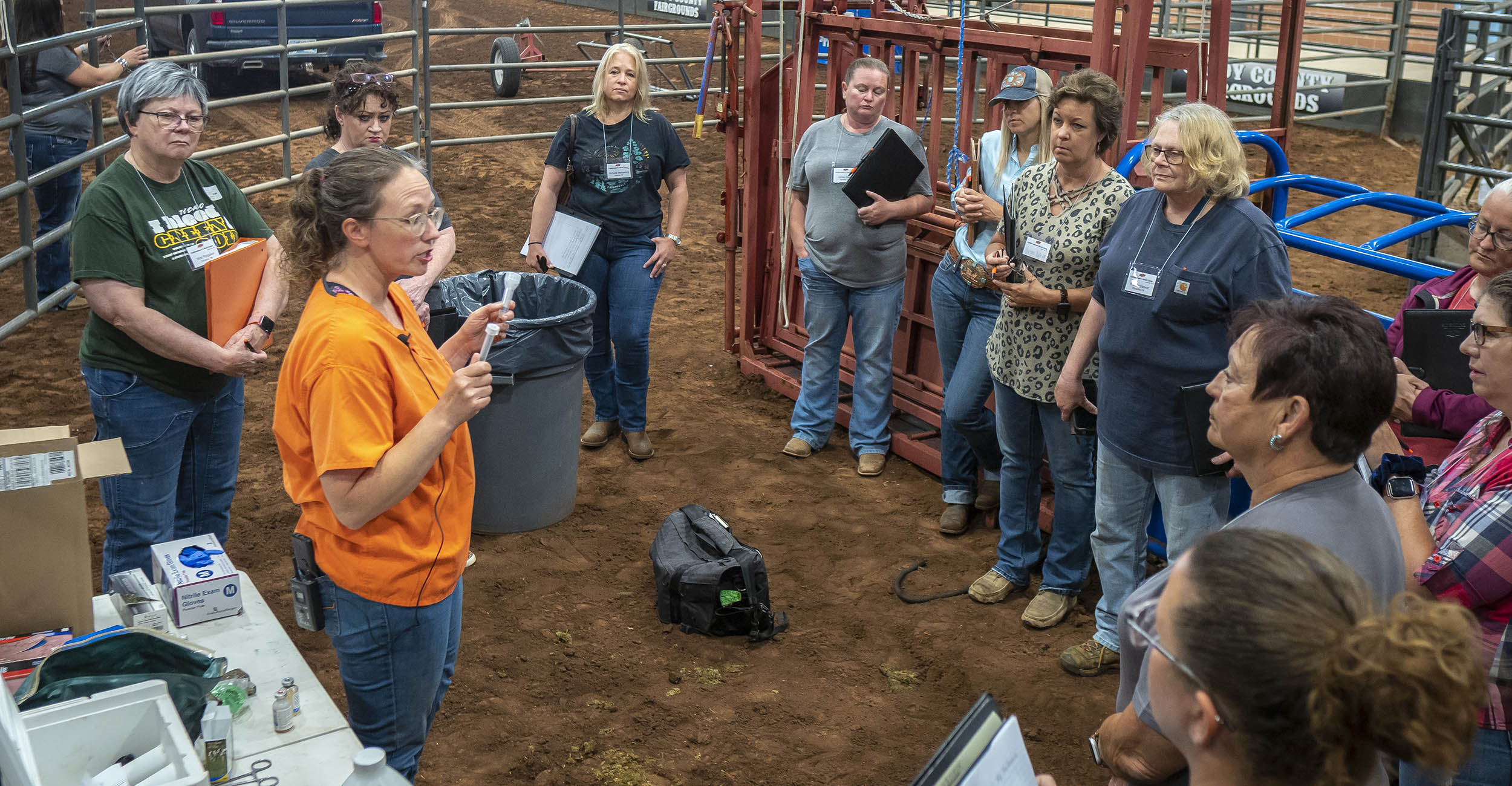 group of women standing in an arena listening to a presentation