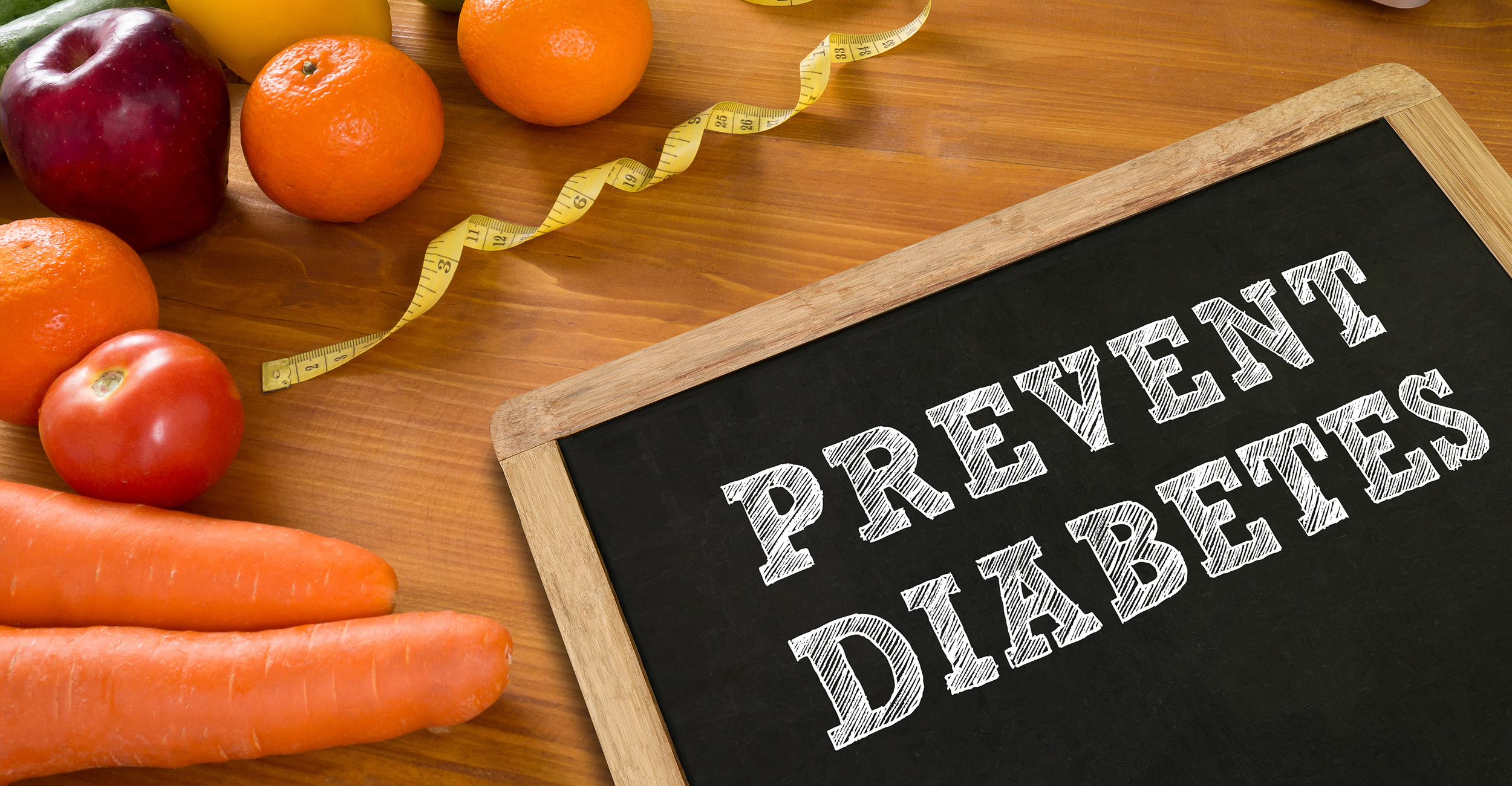 Fruit and vegetables on a table beside a sign that says Prevent Diabetes.