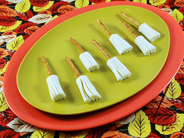 String cheese and pretzel brooms