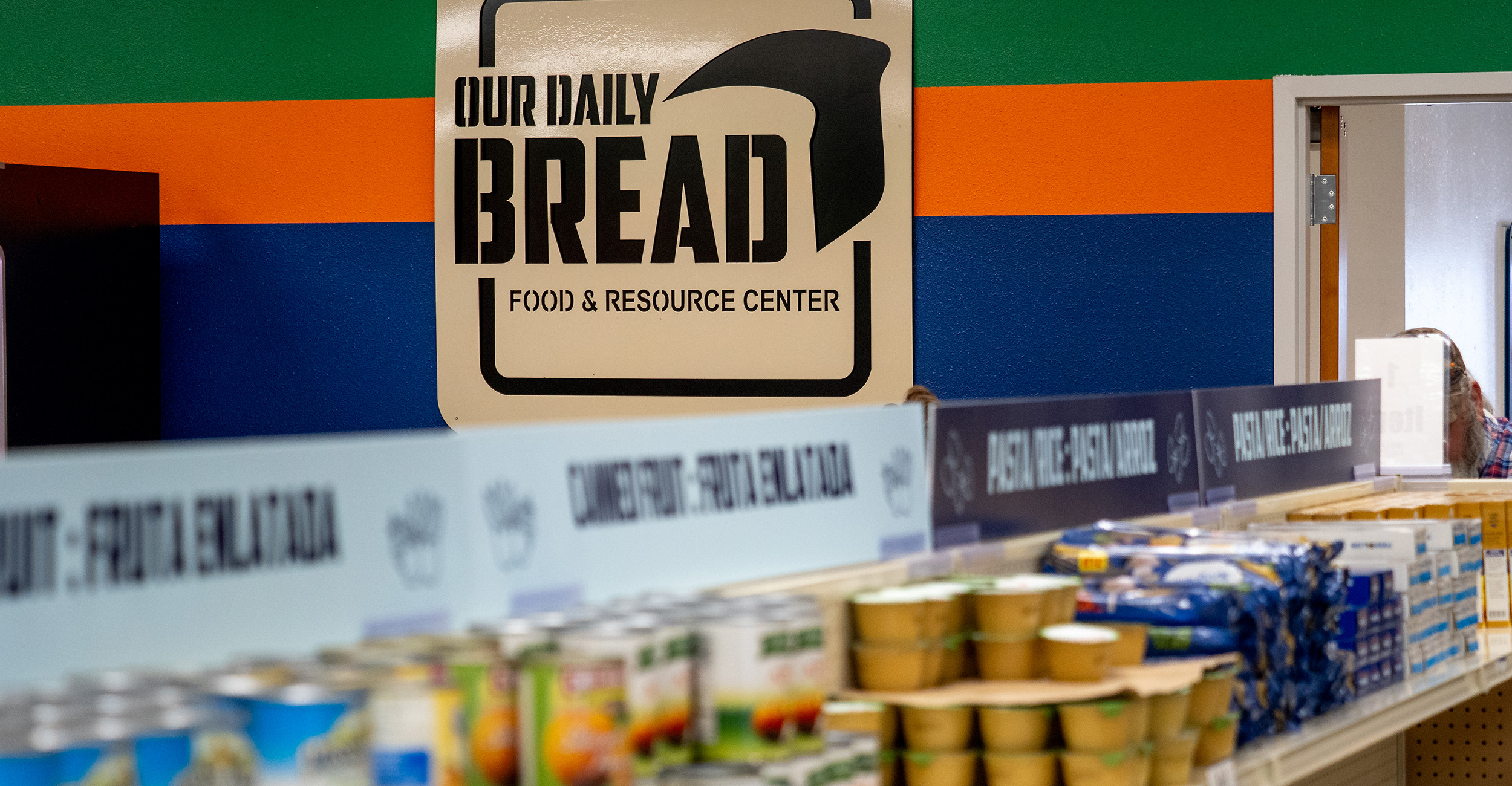 Canned food on shelves at a food pantry.