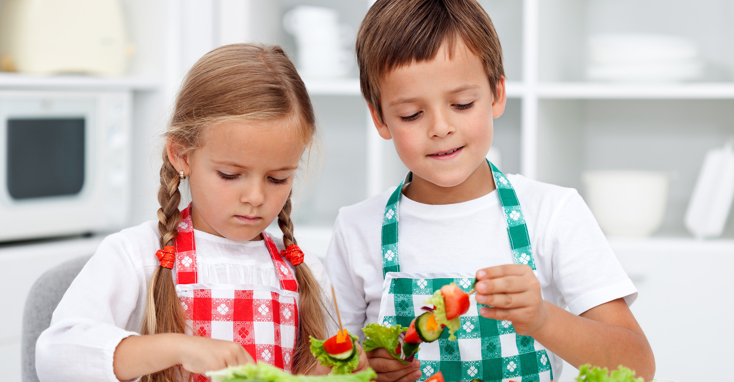 Children preparing food in the kitchen.