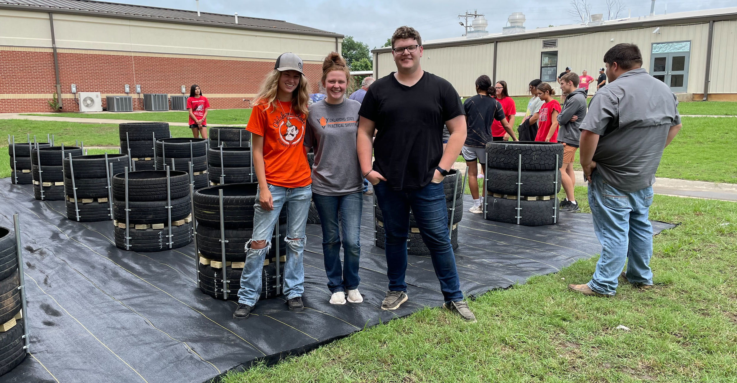 Students standing in front of recycled tire gardens.