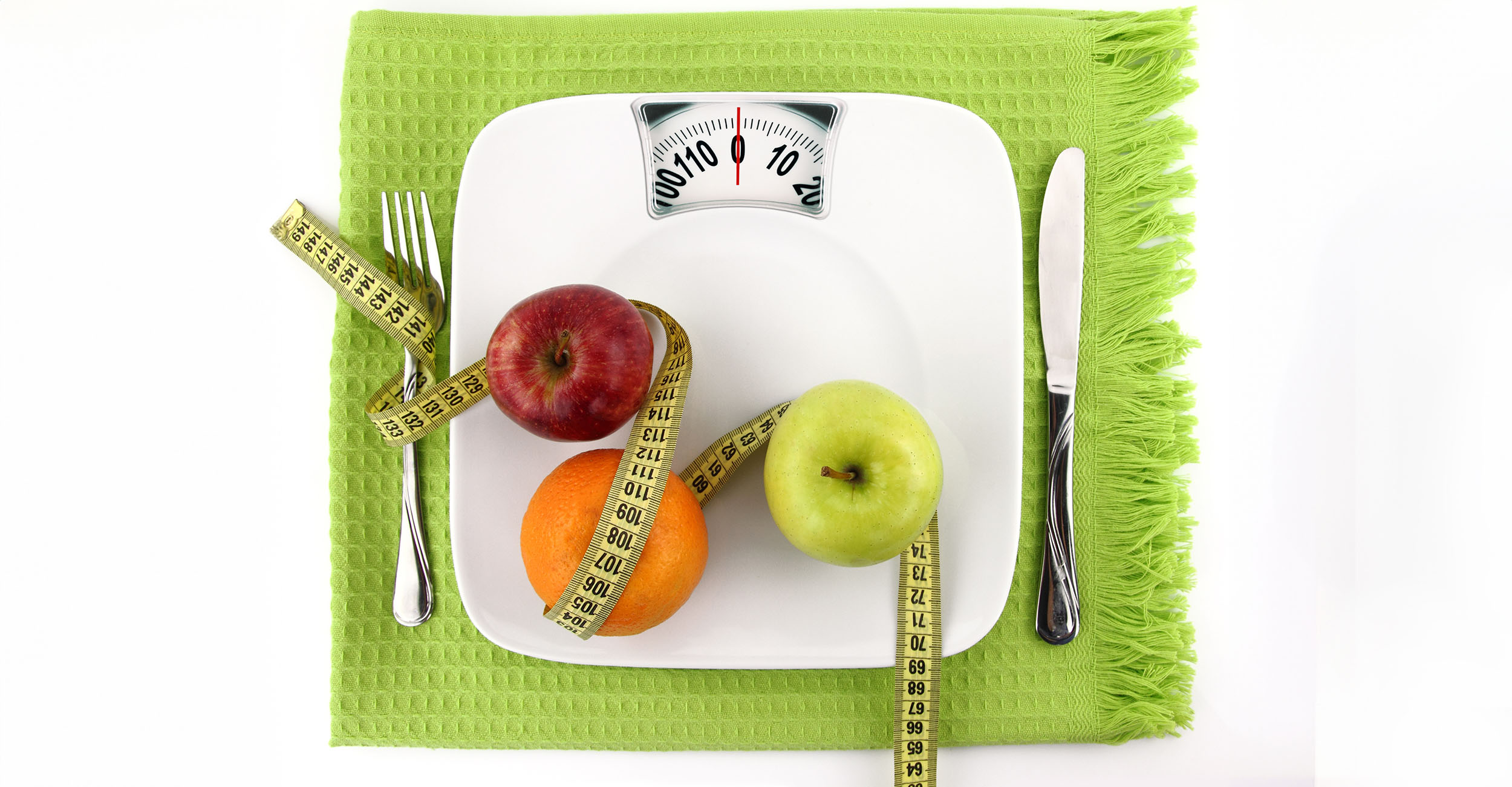 Various fruits on top of a bathroom scale.