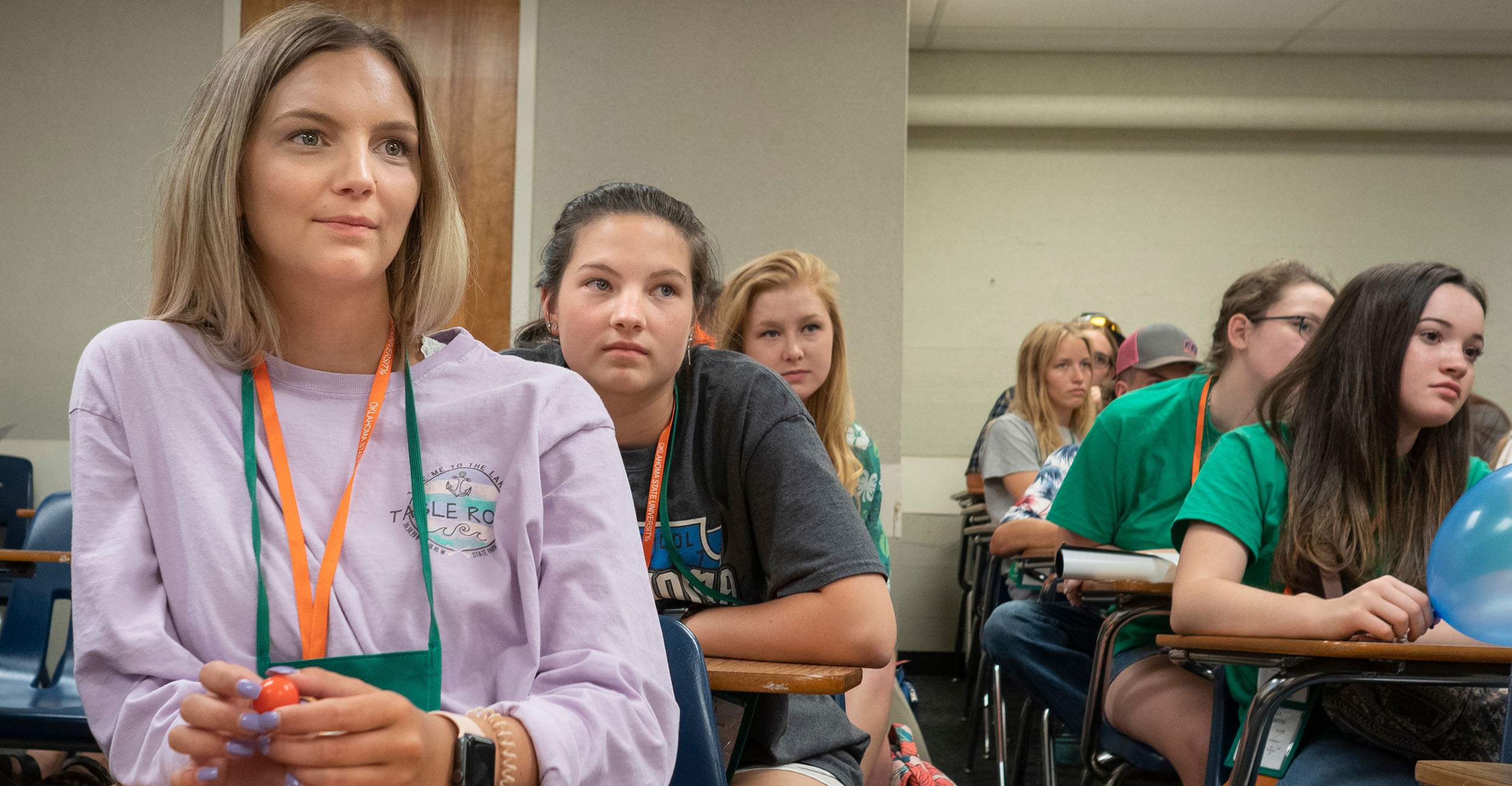 High school students sitting as desks in a classroom.