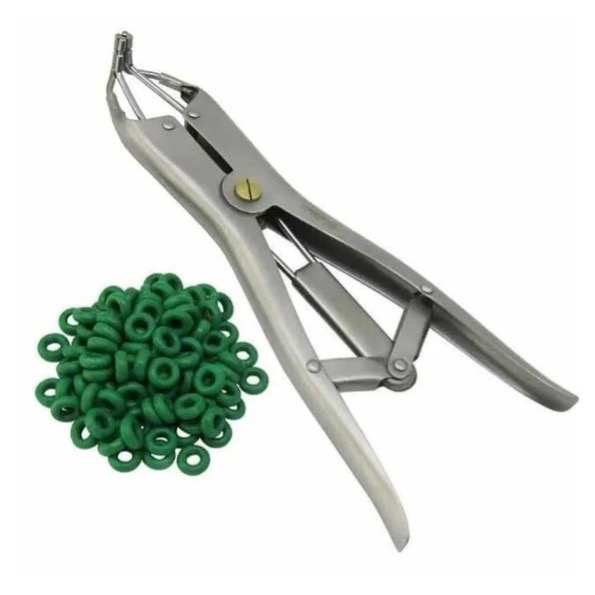 Silver metal pliers with an L-shaped end used to stretch rubber bands, with a pile of green rubber bands beside them.