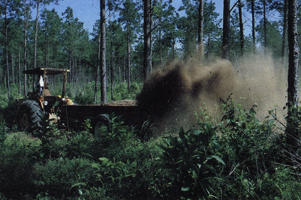 A tractor drawn manure spreader.
