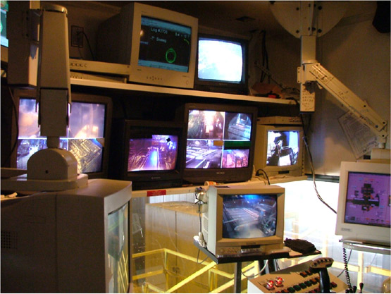 Computer monitors inside a headrig control room.