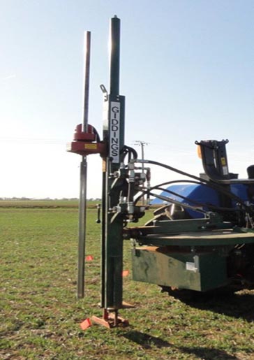 A Giddings Probe taking a sample from the ground.