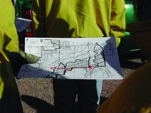 Workers holding an example of a burn map