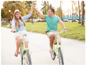 A man and woman riding bikes