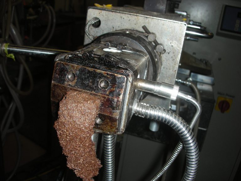 Mixture of wood and plastic coming out from the extruder.