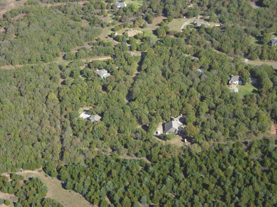 This is an aerial photo of a residential area with quite a bit of cedar.