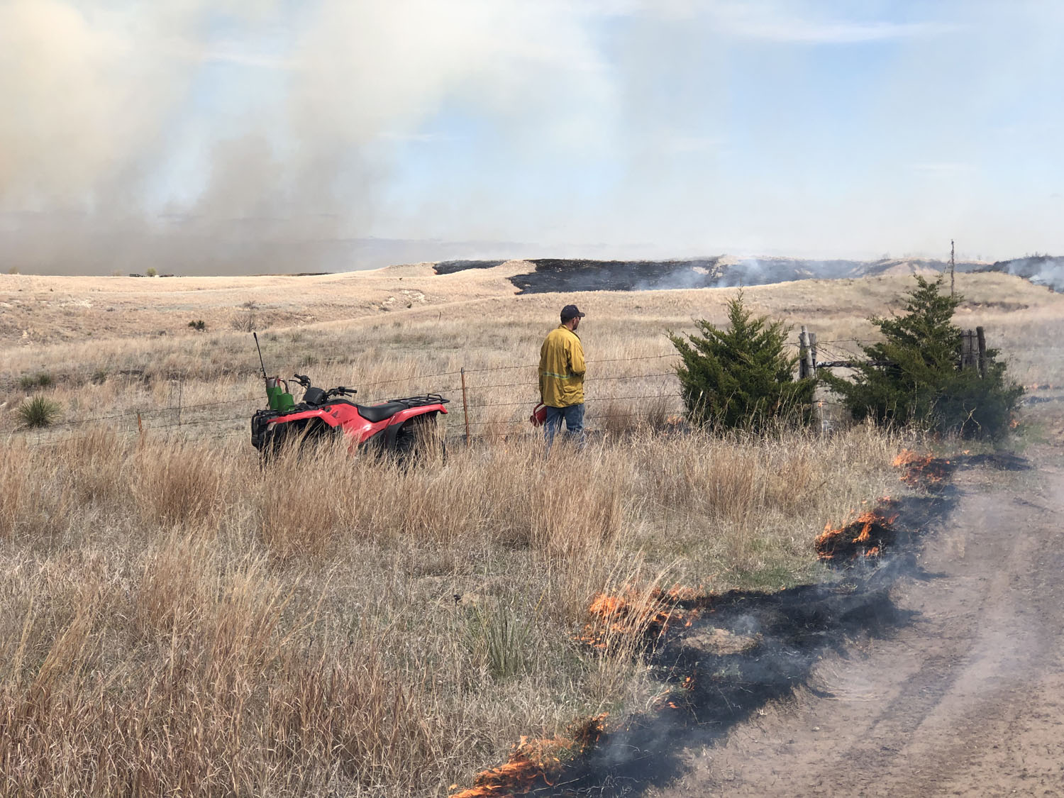 men standing in a field on fire