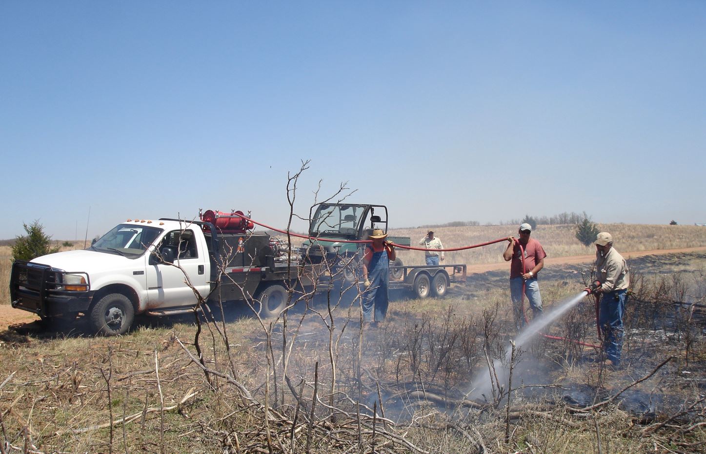Firefighters putting out a fire. Firefighters putting out a fire.