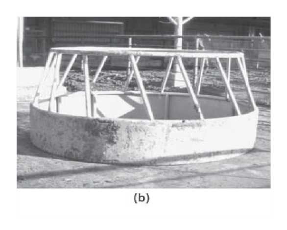 A round metal bale feeders for cattle with tapered bottom.