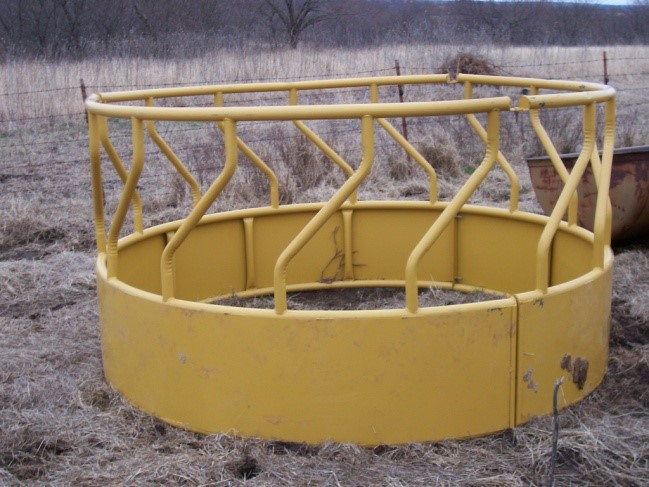 A more thick metal bale feeders for cattle with a tapered bottom.