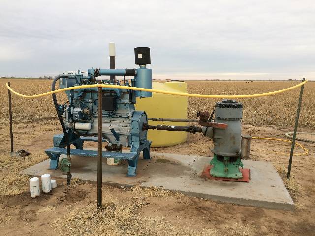 A natural gas engine extracts groundwater in a field for irrigation.