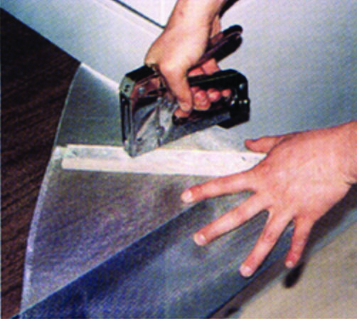 Staple the longer edge of screening to the shorter piece of wood lath to form a cone