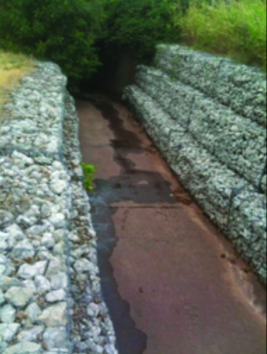 Concrete channel lined with riprap held in place with gabions in Stillwater, OK