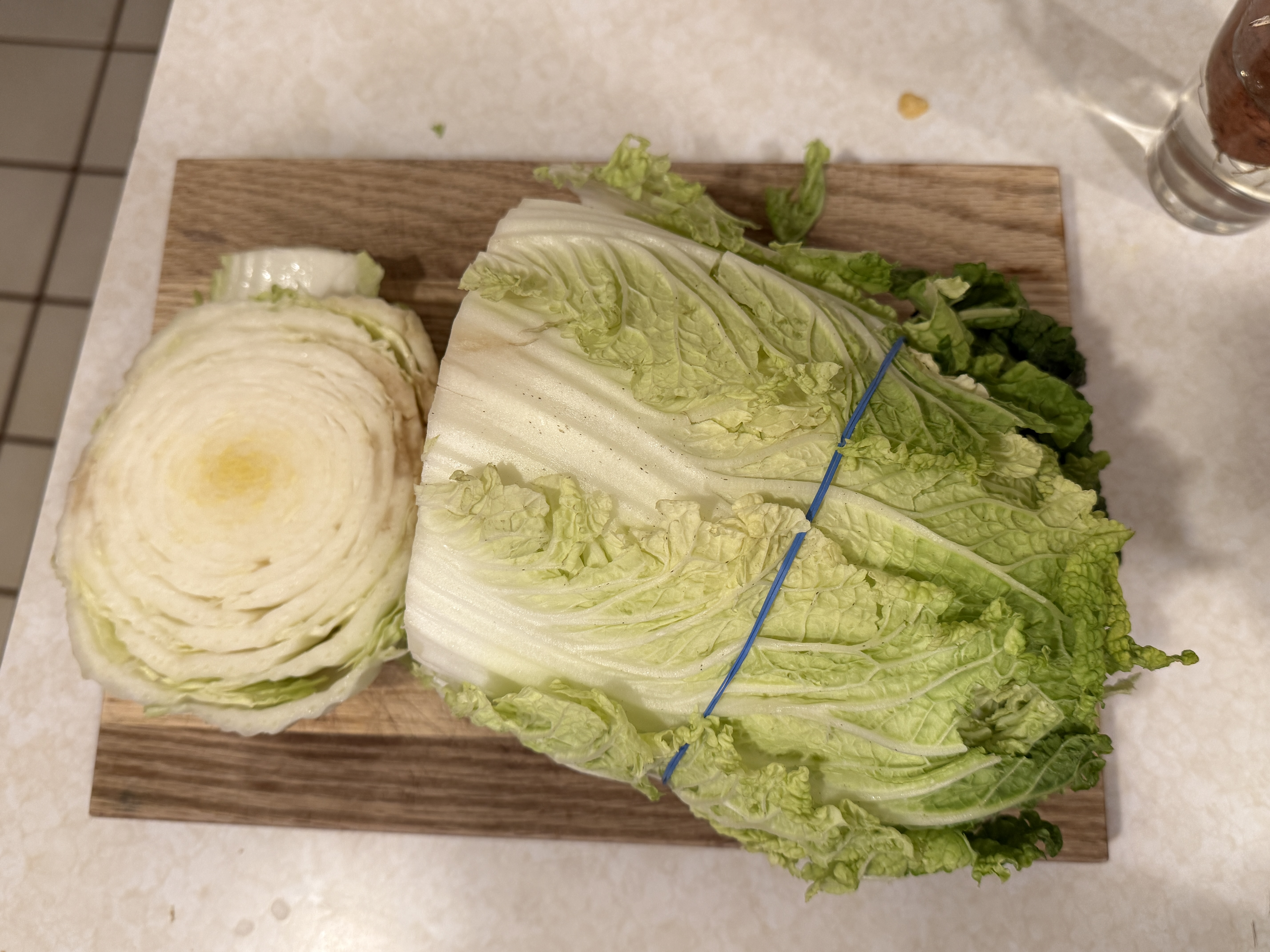 One half of romaine lettuce with a blue line on the top half to indicate where to cut the romaine lettuce.