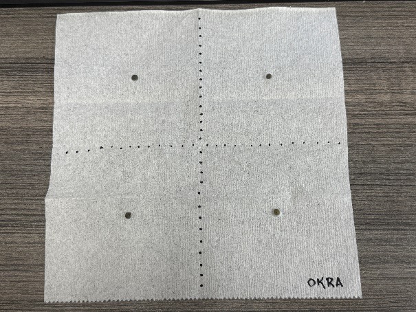 An okra plot drawn on a piece of paper showing four squares, two rows with two squares, with a dot in the center of each square.