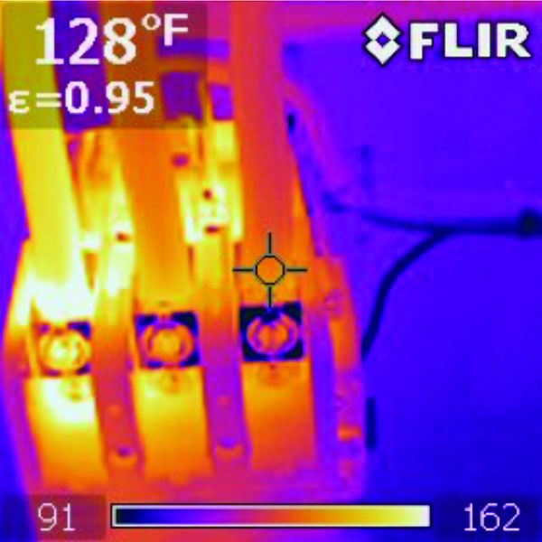 Infrared thermal photo of hot loose connection on three phase fuse box.