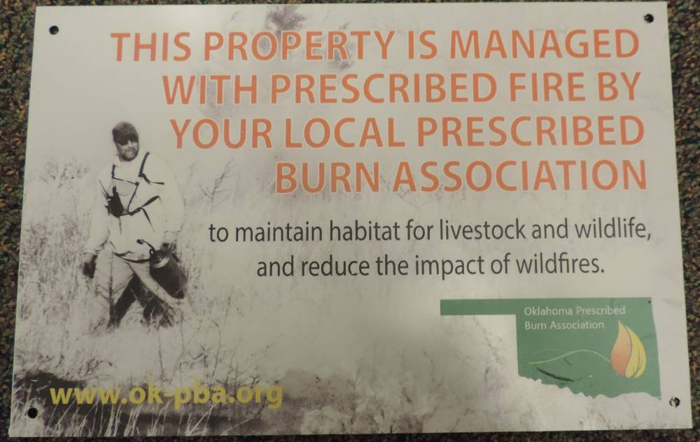 Prescribed burn sign that says this property is managed with prescribed fire by your local prescribed burn association to maintain habitat for livestock and wildlife, and reduce the impact of wildfires.