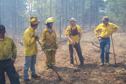 Five people wearning protective gear.