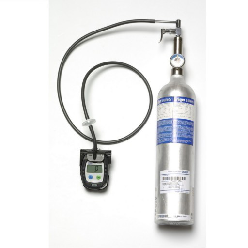 A small black device connected to a silver bottle by a hose. A small black device connected to a silver bottle by a hose.