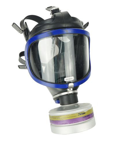 A black gas mask with a small canister attached to the mouth area. A black gas mask with a small canister attached to the mouth area.