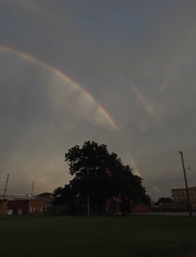 A dark sky with a rainbow.