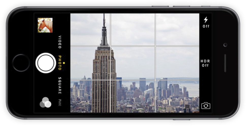 A smart phone sitting horizontally that is on the camera app and capturing s view of the city.