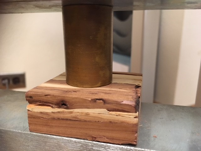 Janka Hardness test set-up with a piece of lumber.
