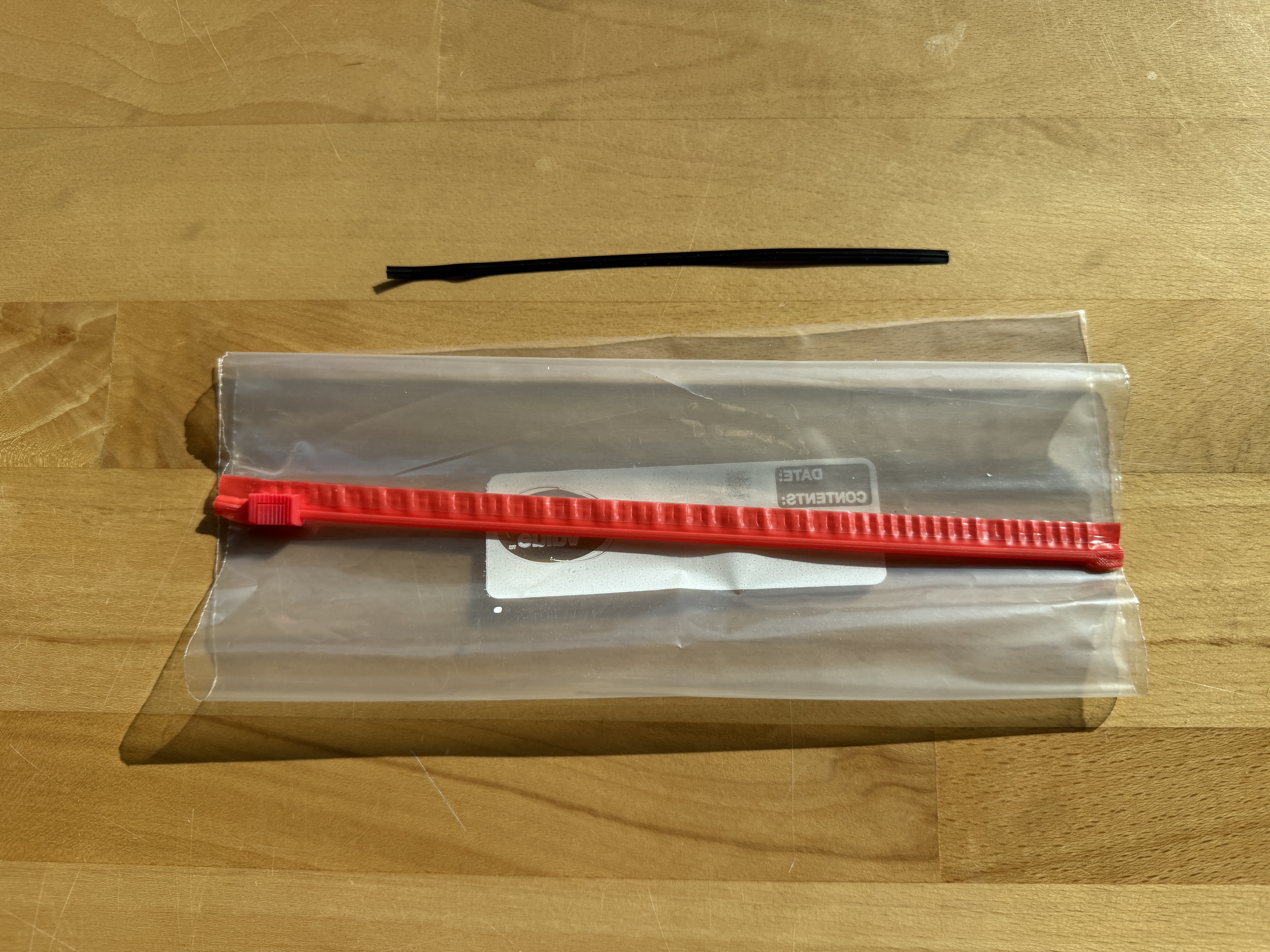 A ziploc bag with a black ziptie on top.