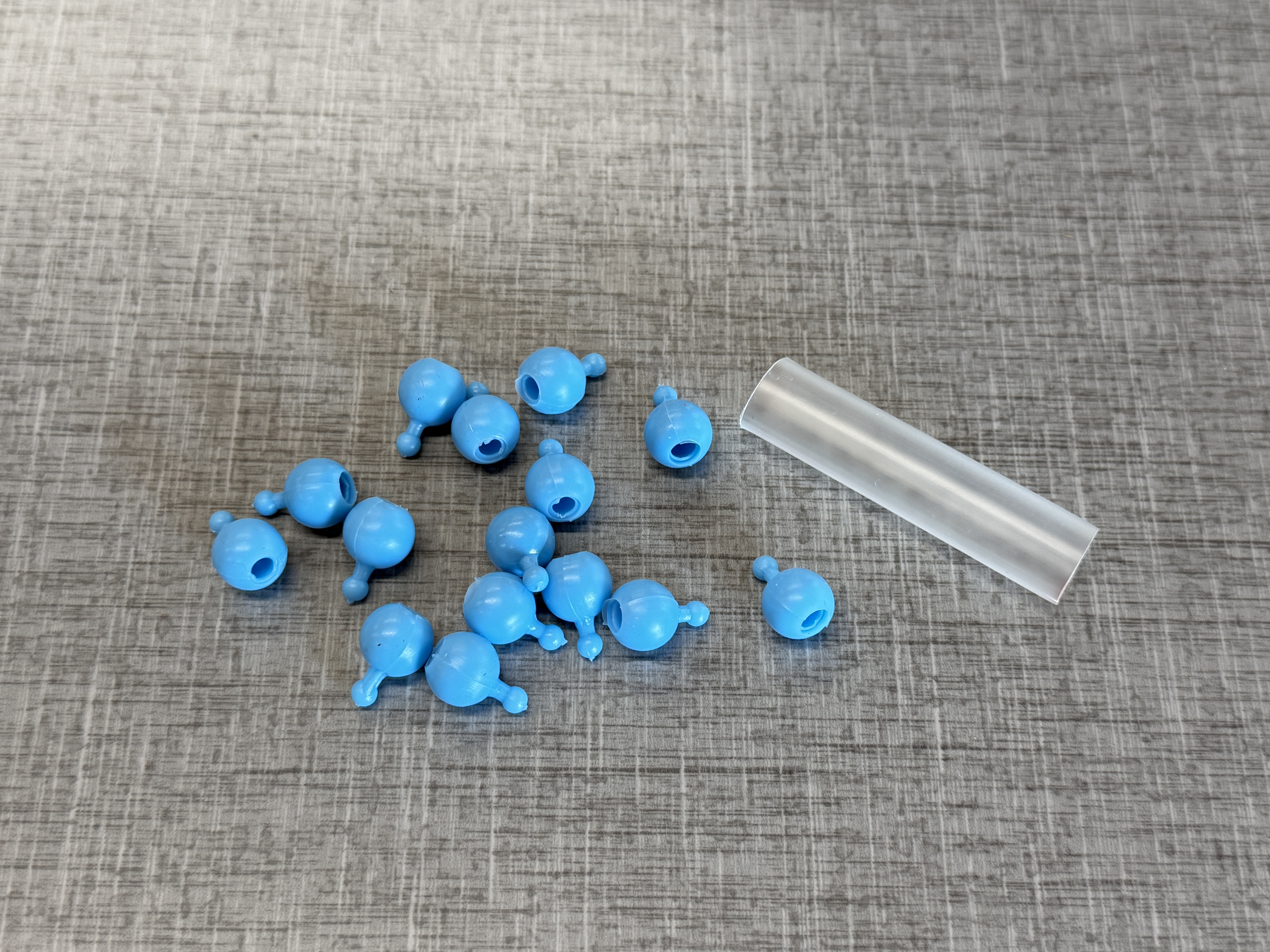 Blue pop beads with a plastic circular container.