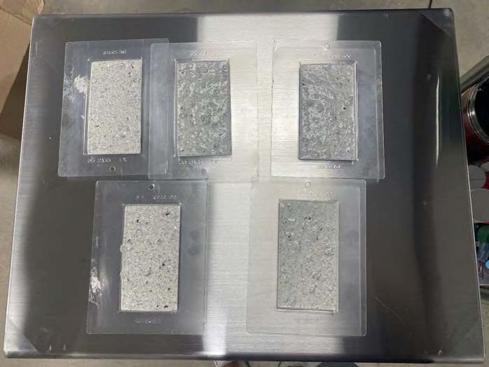 Bar molds filled with white-chocolate and cookie crumbs