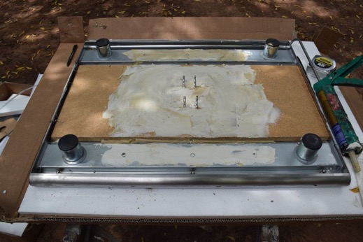 White color adhesive spread on board and on four support channels.