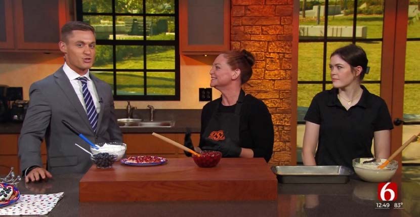 A news anchor with two guests on the Channel 6 cooking corner segment.