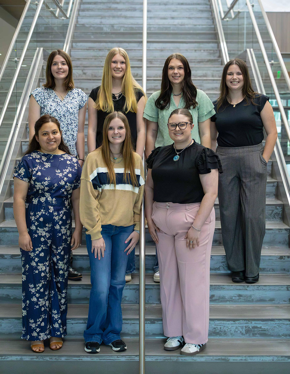OSU Extension Interns Five OSU Extension interns standing together on a staircase in two rows for a group photo.