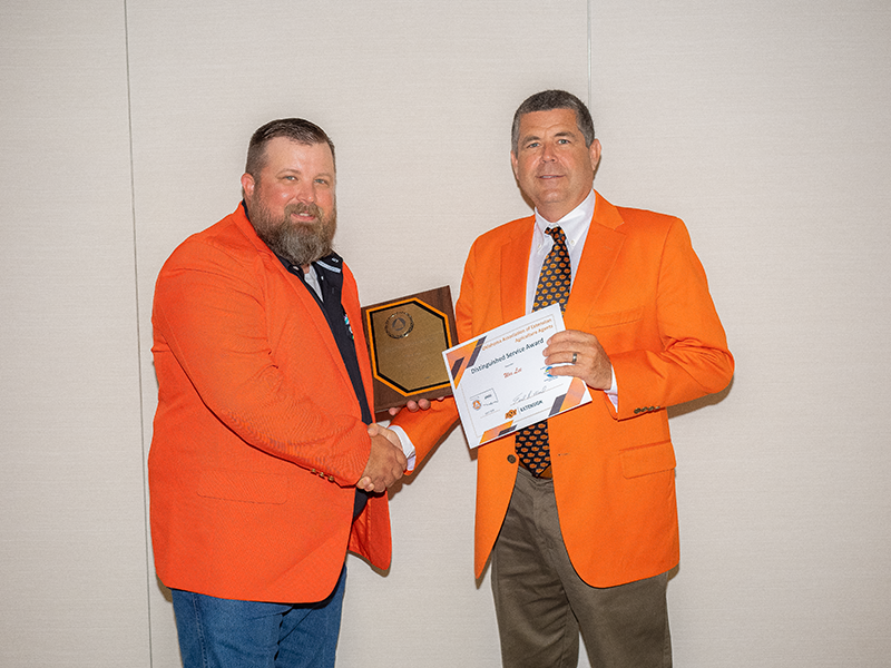 A man giving another man an award.