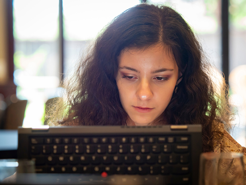 A woman working on a computer.