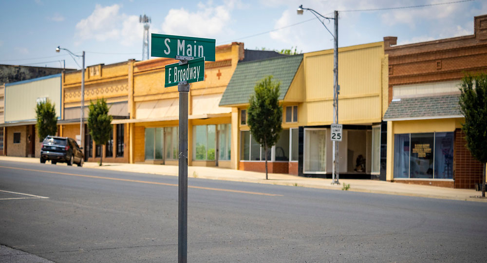 A street sign for S Main street and buildings in the background. A street sign for S Main street and buildings in the background.
