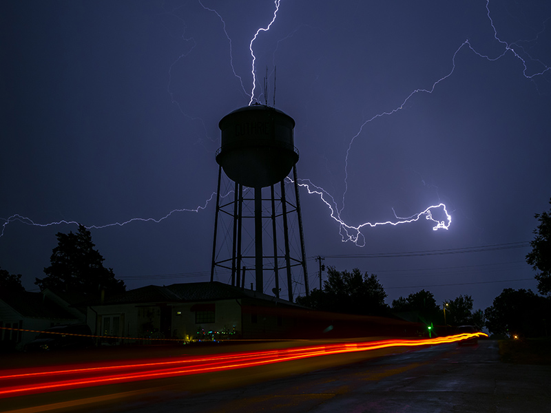 Water Tower with lightning across the sky