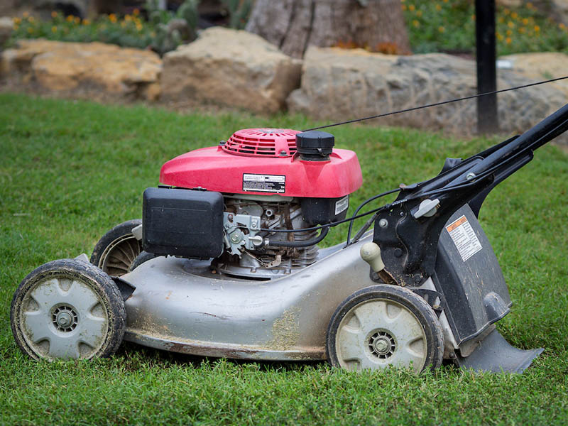 A mower placed on the grass.