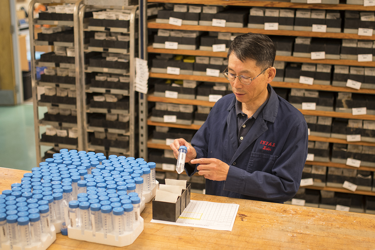 A man testing soil samples in the lab.