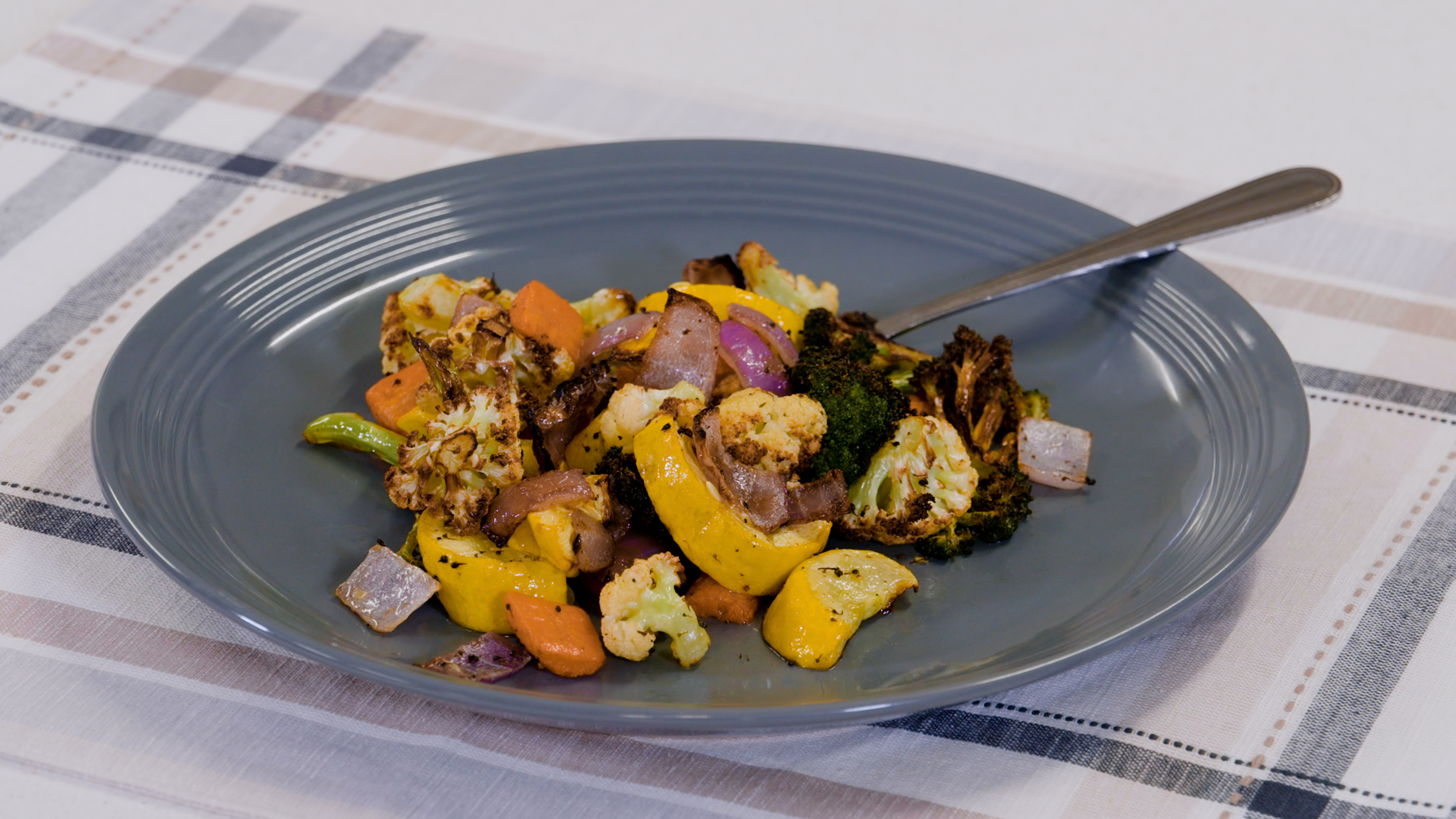 Veggies on a blue plate that were made in the air fryer.