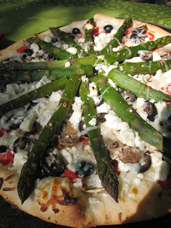 Asparagus pizza on a plate.